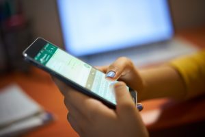 girl typing phone message on social network at nig PPVUP54
